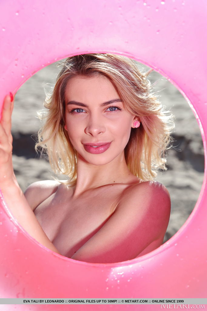 Eva Tali is out on the beach on her pink floater